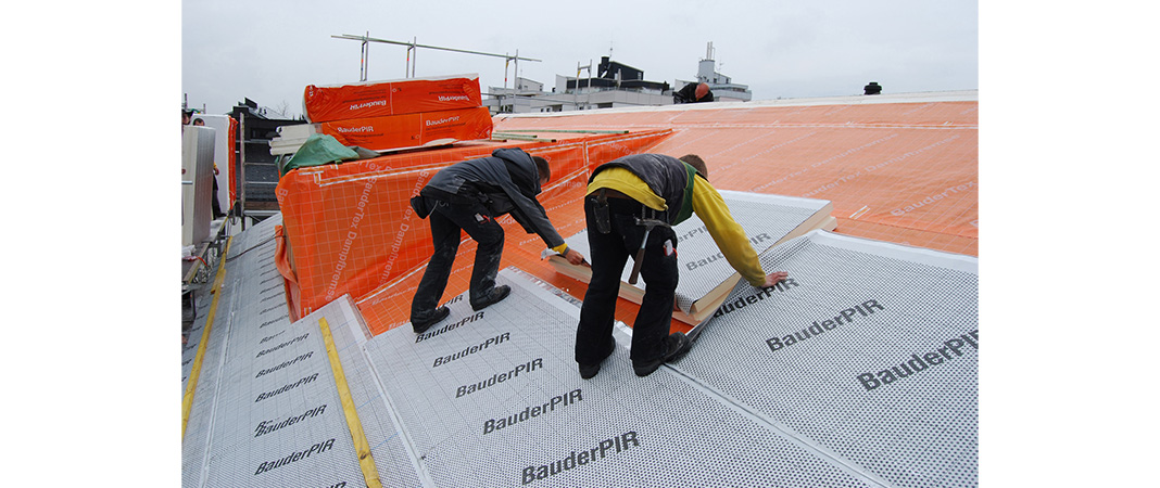 Bild von Dachdeckern bei der Verlegung einer Aufsparrendämmung